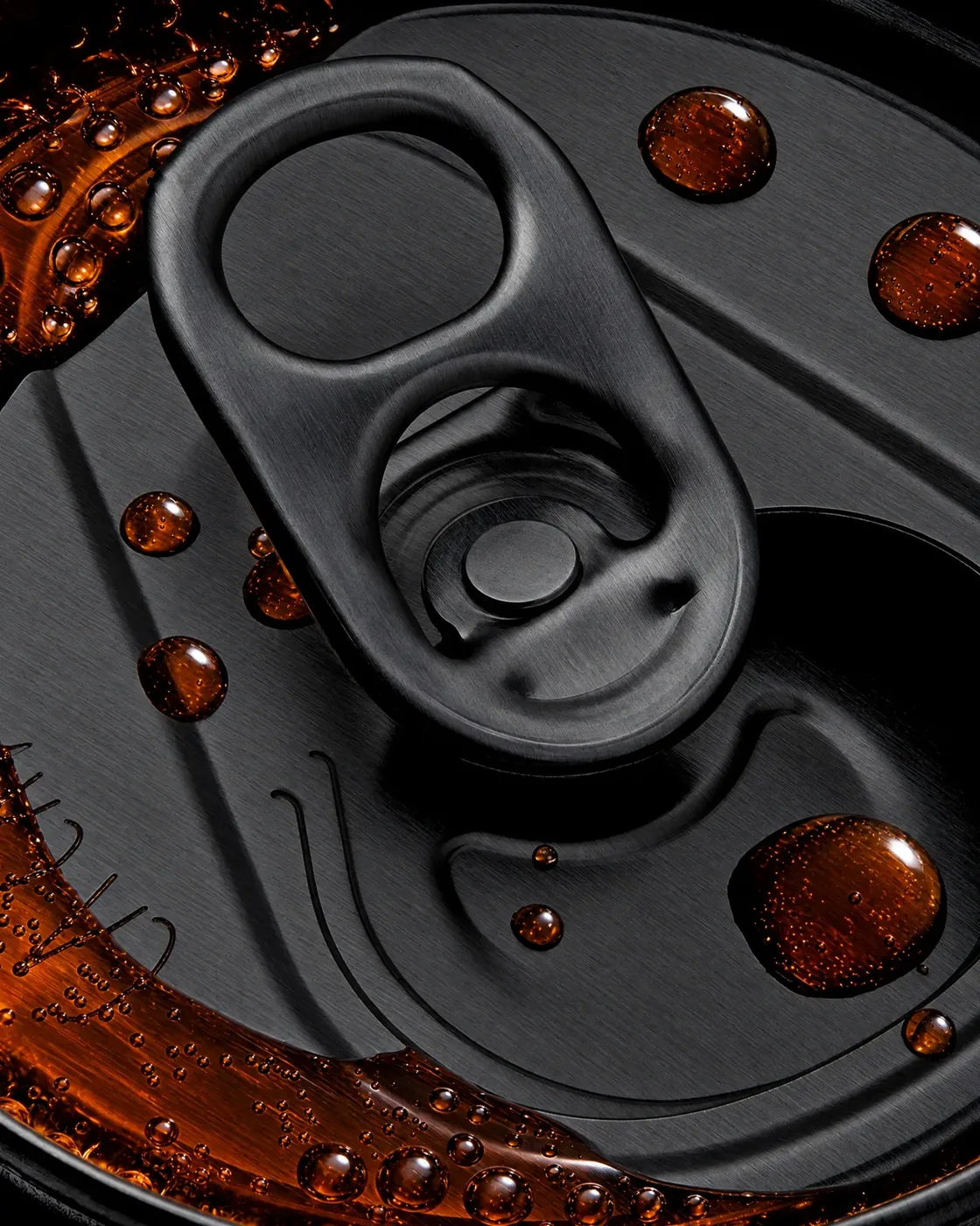 Close-up of a black can lid and ring-pull with cola droplets