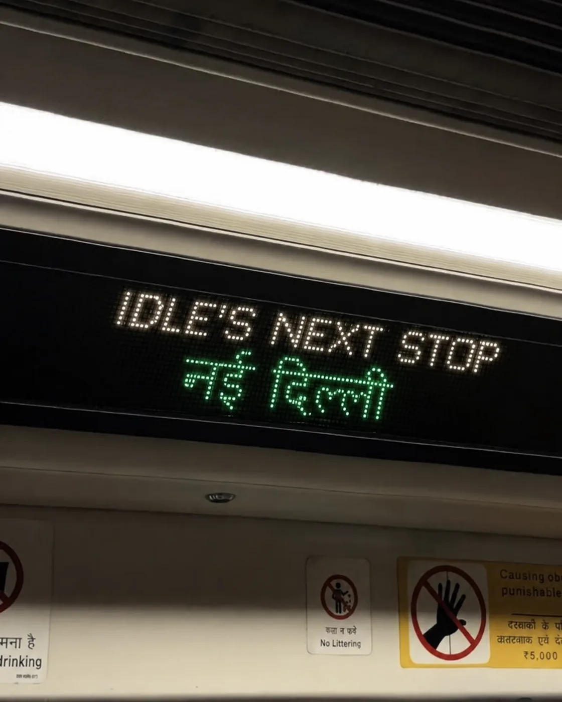 A metro display reading IDLE's next stop, Nai Dilli